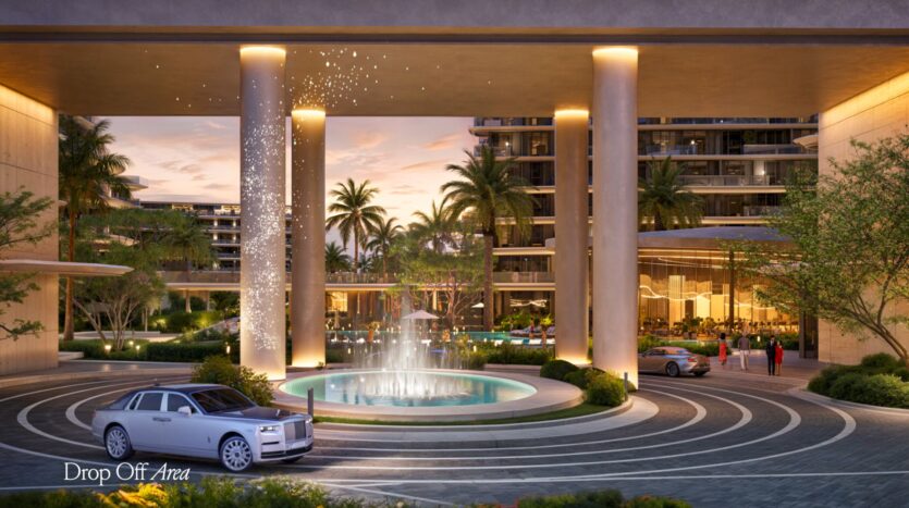 A drop-off area at a luxury hotel at sunset, featuring a circular driveway adorned with a fountain, tall columns, high-end cars parked like a Meriva, palm trees, and modern glass buildings in the background.