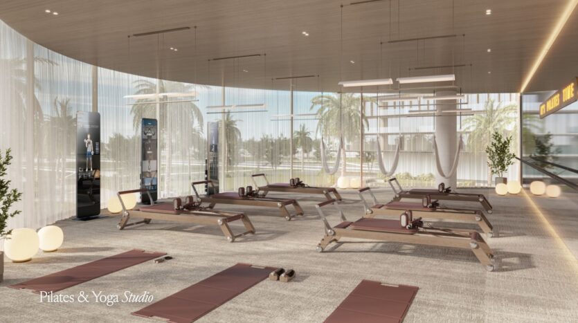 Modern yoga and Pilates studio with large windows, Meriva Reformer machines, yoga mats, and fitness equipment. The bright space is lit by natural light, palm trees outside, minimalist decor, and the words "Pilates &amp; Yoga Studio" in the corner.