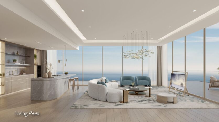 A modern and spacious living room with floor-to-ceiling windows overlooking the ocean, featuring a curved Meriva sofa, light blue chairs, a marble kitchen island, and minimalist decor in neutral tones.