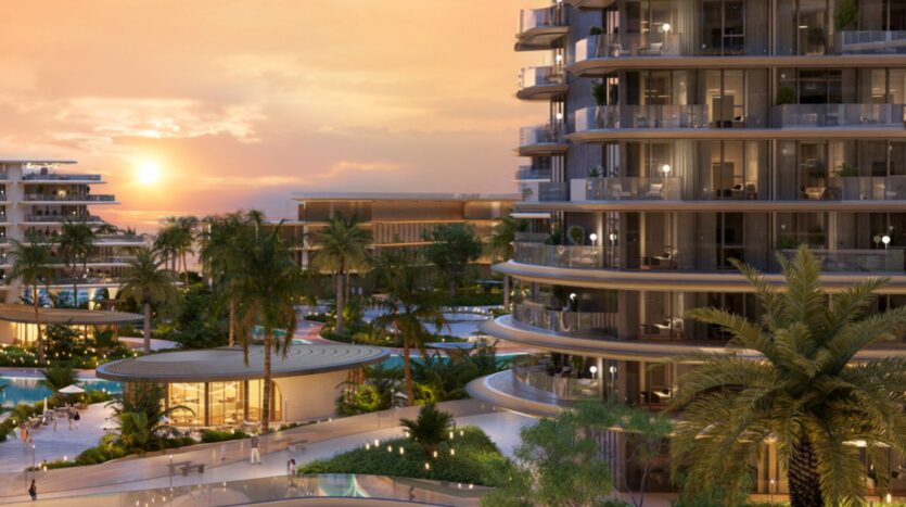 The modern and luxurious Meriva apartments, featuring curved balconies, overlook palm trees, landscaped gardens, and swimming pools at sunset. Warm light reflects off the floor-to-ceiling windows, creating a serene, resort-like atmosphere.