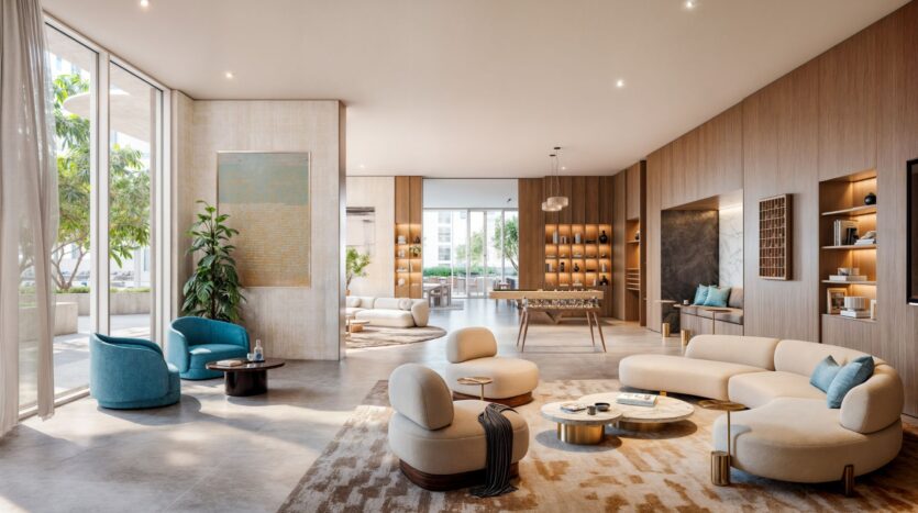 Muheira's modern and spacious living room features curved beige sofas, blue armchairs, round coffee tables, large windows, indoor plants, foosball, built-in shelves, and neutral tones, all bathed in natural light.