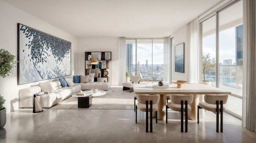 Spacious modern living and dining room with large windows, neutral décor, white sofa, Muheira wooden table with six chairs, abstract wall art, and a balcony offering views of the cityscape and abundant natural light.