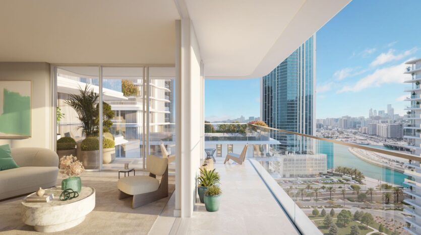 Modern apartment in the Muheira Tower with floor-to-ceiling windows, a spacious balcony, contemporary furniture, indoor plants, and a view of the cityscape with tall buildings, water, and a partly cloudy sky in the background.
