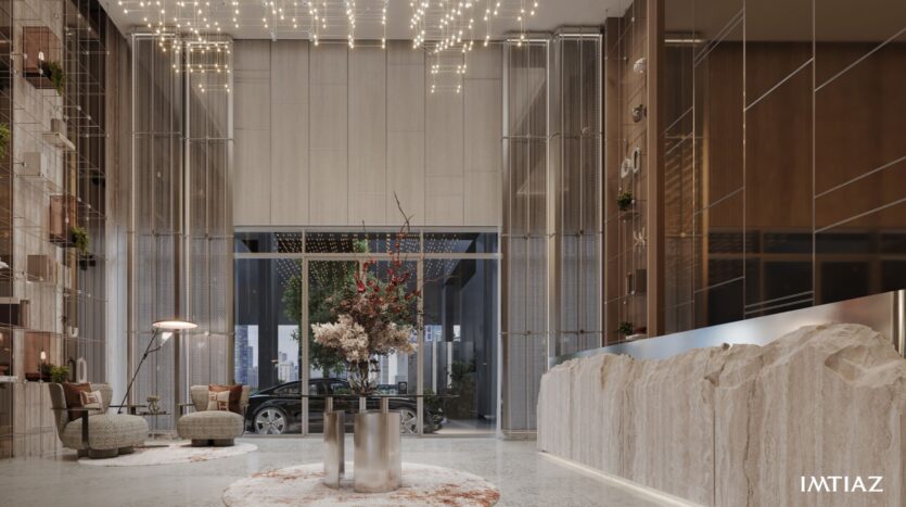 The modern and luxurious lobby at Sea Cliff features high ceilings, elegant lighting, a marble reception desk, comfortable seating, and a large glass entrance. Plants and décor add charm, while a car is visible outside the glass doors. The name "IMTIAZ" appears in the corner.