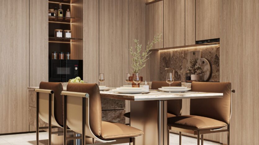 Modern Sea Cliff kitchen with light wood cabinets, a marble dining table for four, brown leather chairs, and built-in shelves with jars. Soft lighting and minimalist decor create a warm and welcoming atmosphere.