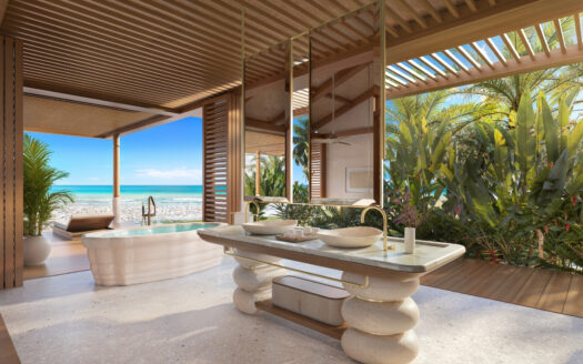 Luxuriöses Open-Air-Badezimmer mit modernen Waschbecken aus Stein und einer freistehenden Badewanne mit Blick auf einen tropischen Strand – ein exklusiver Rückzugsort von Dar Global mit Blick auf den Ozean und den blauen Himmel unter einem Holzdach.