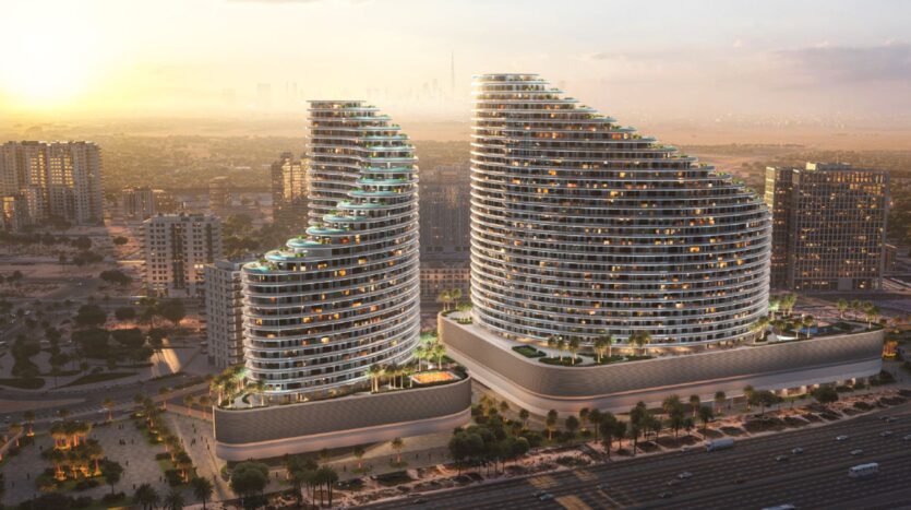 An aerial view of two modern, curved skyscrapers with tiered balconies and rooftop pools, surrounded by a cityscape and roads that glisten in the glow of a Skyflame sunset.