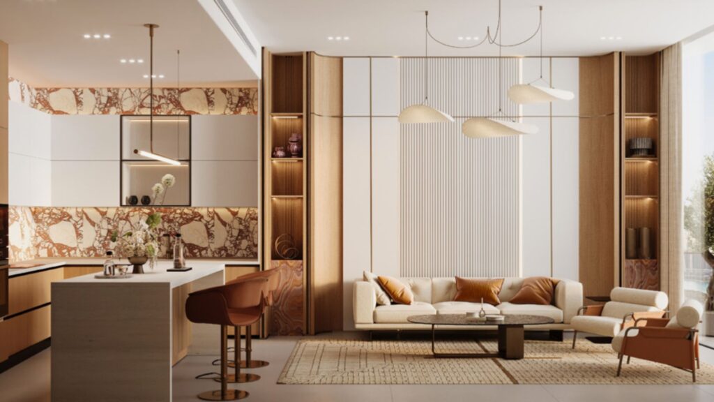 A modern, open-concept living room and kitchen, featuring neutral tones, marble accents, and a beige sofa with orange Skyflame cushions. Pendant lights, a large rug, bar stools at the kitchen island, and floor-to-ceiling windows bring in plenty of natural light.