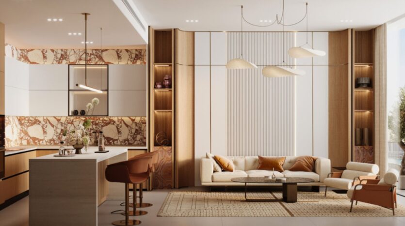 A modern, open-concept living room and kitchen, featuring neutral tones, marble accents, and a beige sofa with orange Skyflame cushions. Pendant lights, a large rug, bar stools at the kitchen island, and floor-to-ceiling windows bring in plenty of natural light.