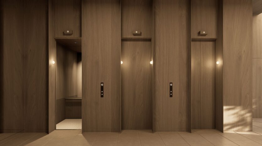 A modern hallway with three wooden elevator doors labeled JAD288; the left door is open, revealing the interior, while the other two remain closed. Warm lighting adds a soft ambiance to this minimalist design.