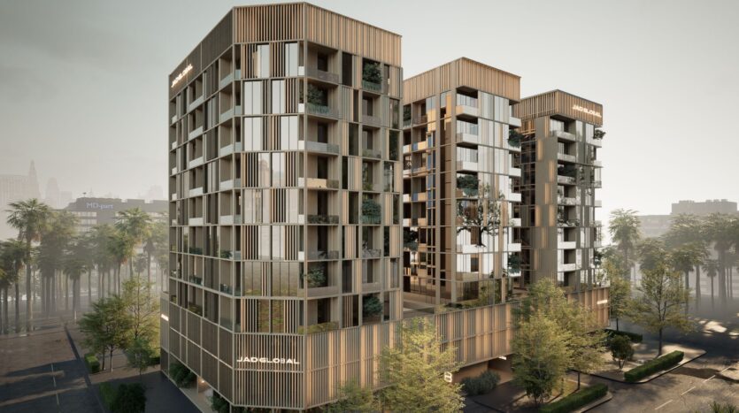 Three modern multi-story buildings, marked JAD288, feature large bay windows, wood panel facades, and balconies with greenery. Surrounded by trees, "JADE FLORA" is visible on two of the buildings' facades.