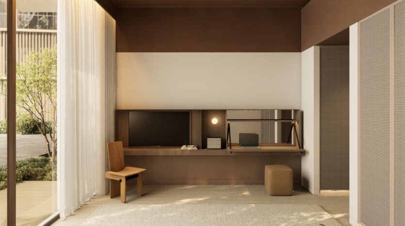 A modern, minimalist workspace featuring the JAD288 desk, a computer screen, a lamp, a mirror, a wooden chair, an ottoman, and floor-to-ceiling sheer curtains that let in light from the garden. Neutral brown and beige tones create a soothing atmosphere.