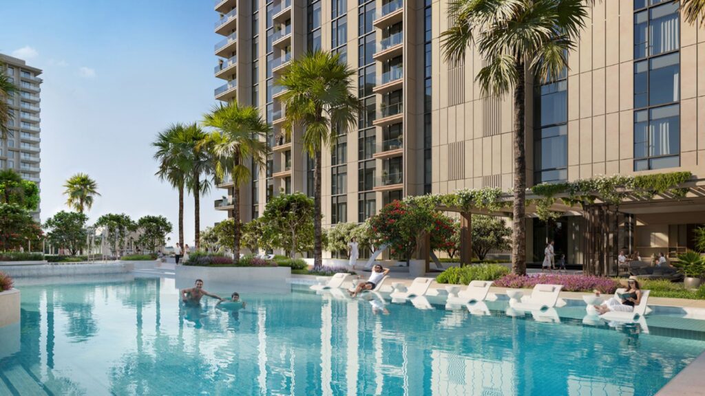 Tara Park est un complexe d'appartements moderne avec de grands bâtiments, des palmiers et une grande piscine extérieure. Les gens se détendent sur des chaises longues et dans la piscine, profitant d'une journée ensoleillée.