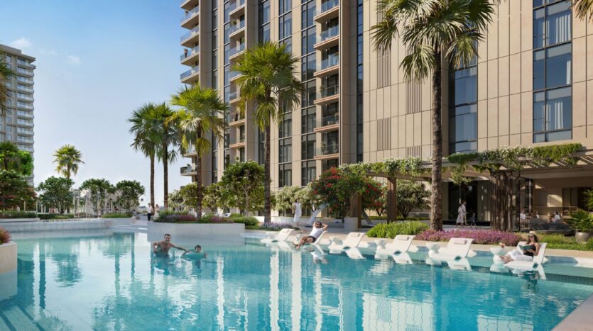 Tara Park est un complexe d'appartements moderne avec de grands bâtiments, des palmiers et une grande piscine extérieure. Les gens se détendent sur des chaises longues et dans la piscine, profitant d'une journée ensoleillée.