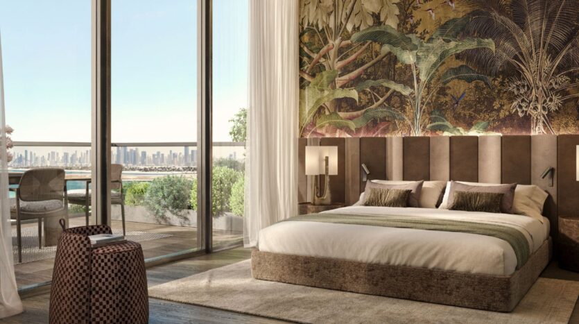 A modern room at Cheval Residences featuring a king-size bed, tropical-themed murals, floor-to-ceiling windows, and a balcony overlooking the city skyline and lush greenery. Natural light floods the room, which is furnished with contemporary pieces and decorated in neutral tones.