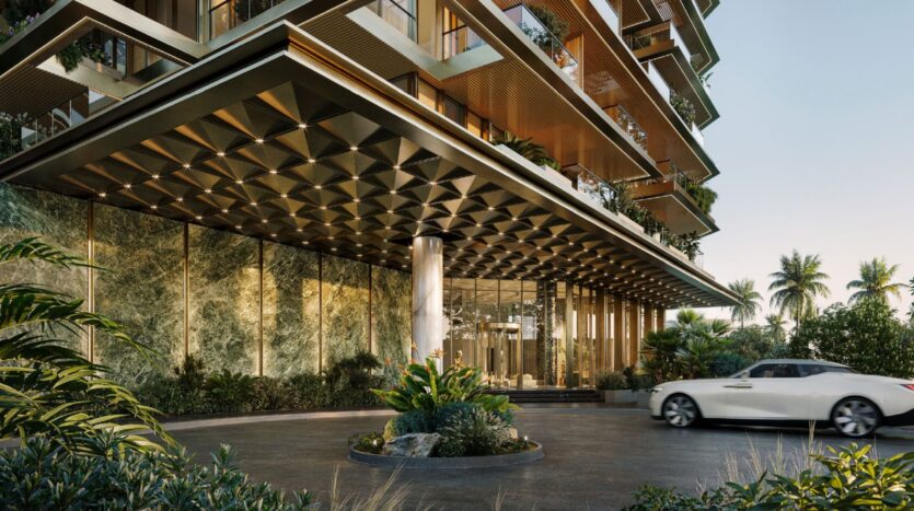 The modern entrance to Cheval Residences features a geometric metal canopy, floor-to-ceiling glass walls, lush greenery, and a white convertible parked near the entrance. The bright scene is enhanced by greenery and palm trees.