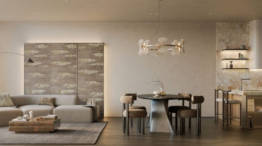 Modern living and dining rooms in the Cheval residences, featuring a beige sectional sofa, textured wall panels, a round table with four chairs, a single chandelier, minimalist decor, and built-in shelving in a neutral color palette.