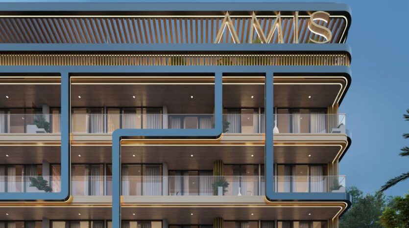 The facade of a modern building featuring numerous balconies and large windows, with clean blue lines and bright accents. The upper section displays large illuminated letters spelling out "INNS" against the night sky of Derby Heights.