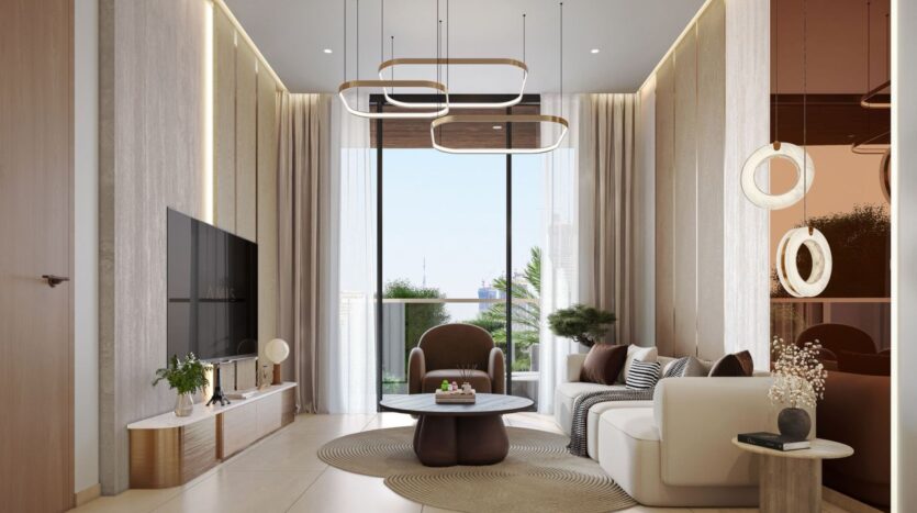 The modern living room at Derby Heights features neutral tones, a large window, contemporary furniture, a circular rug, a wall-mounted TV, geometric light fixtures, and natural light streaming in, with plants visible outside.