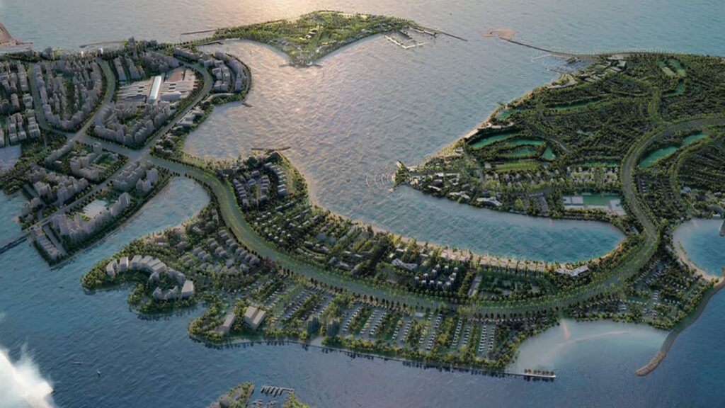 Vue aérienne d'une ville côtière avec des espaces verts, des routes sinueuses et des résidences Meriden Beach sur plusieurs îles entourées d'eau, reliées par des ponts, sous un soleil couchant.