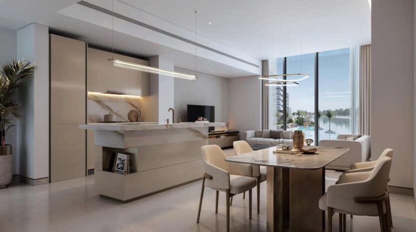 A modern kitchen and living area with minimalist decor, marble countertops, a dining table for four, large windows, elegant lighting, and views of the water and trees: enjoy a sophisticated experience at River Cove Residences.