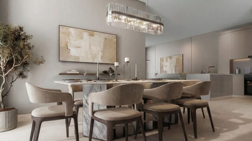 The modern dining room at The Terraces by Sobha features a rectangular table that seats six, beige upholstered chairs, a large abstract painting, a geometric chandelier, and a potted plant, all in neutral tones and a minimalist style.