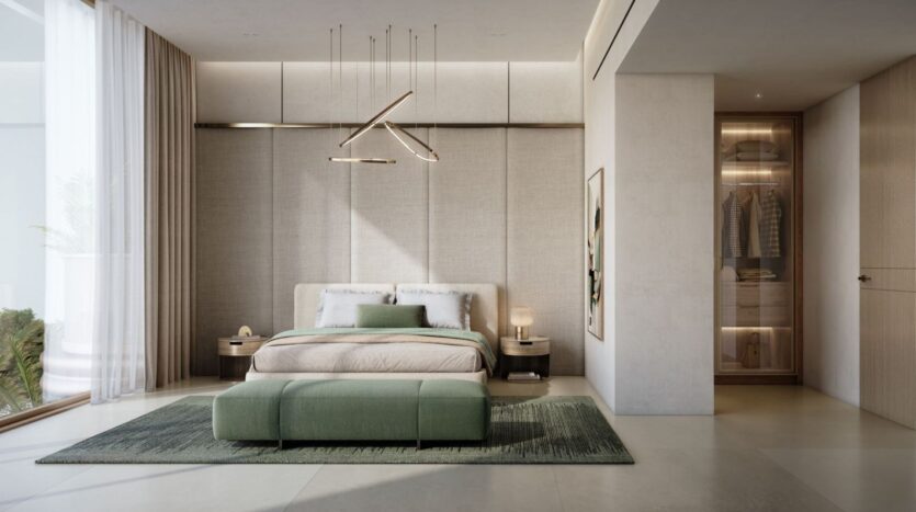 A minimalist bedroom with a neutral color scheme, featuring a large bed with light-colored bedding, a green bench at the foot of the bed, modern nightstands, an open wardrobe with clothes, and *The Tides* by Amis displayed on a shelf as part of a serene decor.