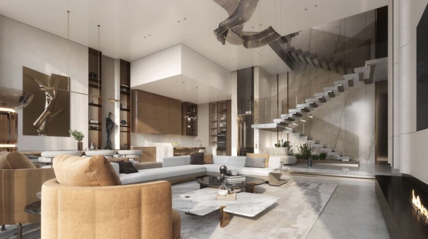 The spacious, modern living room at The Tides by Amis features neutral tones, contemporary furniture, a marble coffee table, a floating staircase, large windows, and elegant lighting. The open-concept layout includes an open kitchen and decorative accents.
