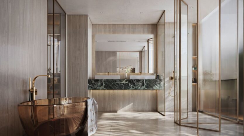 A modern bathroom featuring a freestanding bronze bathtub from The Tides by Amis, two sinks with dark green marble countertops, large mirrors, a glass shower, and floor-to-ceiling light wood paneling, all bathed in natural light thanks to tall windows.