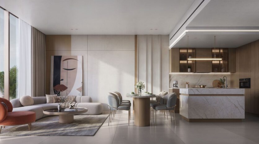 Modern living and dining areas at The Tides by Amis, featuring a beige sofa, a round coffee table, abstract artwork, an elegant dining table for six, and a stylish kitchen with marble countertops and wooden cabinets. Large windows let in plenty of natural light.
