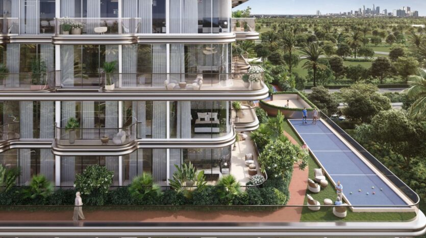 The modern apartment building The Tides by Amis features large glass-enclosed balconies overlooking a garden and a pétanque court. The property is surrounded by lush greenery, and on clear days, you can see the city skyline in the distance.