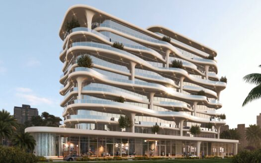 Immeuble Coralis moderne de plusieurs étages avec des balcons blancs incurvés, de grandes baies vitrées et des terrasses verdoyantes. Des palmiers et des voitures sont visibles au premier plan, avec un paysage urbain en arrière-plan.