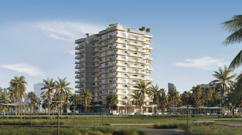 Cybele by Wadan est un immeuble d'appartements moderne de plusieurs étages, doté de nombreux balcons et entouré de palmiers et de verdure, sous un ciel bleu clair en milieu urbain.