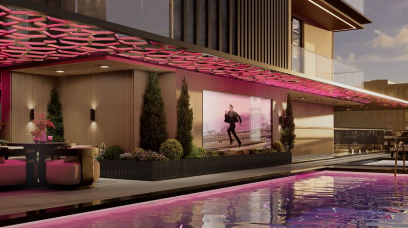 Une résidence moderne de Fauchon avec un éclairage d'accentuation rose, des sièges au bord de la piscine, des plantes en pot et une grande photo murale d'un homme en costume. La piscine reflète les lumières roses dans le cadre élégant de la soirée.