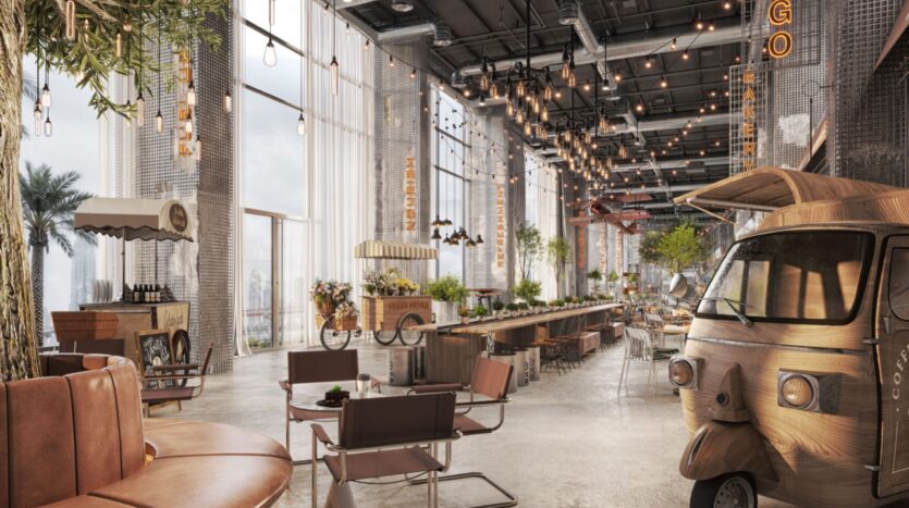 Café spacieux et moderne, Raw District by Imtiaz est doté de hauts plafonds, de grandes fenêtres, de guirlandes lumineuses, de plantes d'intérieur, de sièges en bois, de chariots de marché et d'un food truck de style ancien, le tout dans une atmosphère animée et accueillante.