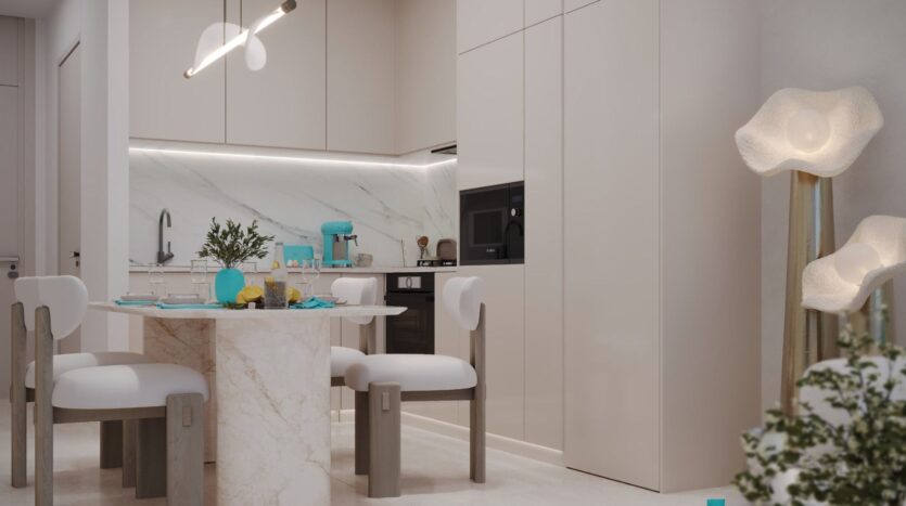 Cuisine et salle à manger modernes avec des armoires blanches, une table en marbre, des chaises rembourrées, des appareils de cuisine Reef 996 turquoise et des lampadaires uniques à lueur douce. Une plante verte est partiellement visible dans le coin inférieur droit.