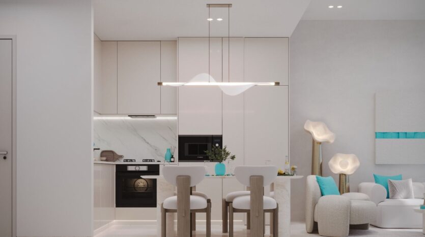 Cuisine et salle à manger modernes avec des armoires blanches, des appareils encastrés et un décor minimaliste. Les coussins turquoise Reef 996 sur les chaises de la petite table et l'éclairage doux créent une atmosphère lumineuse et confortable.