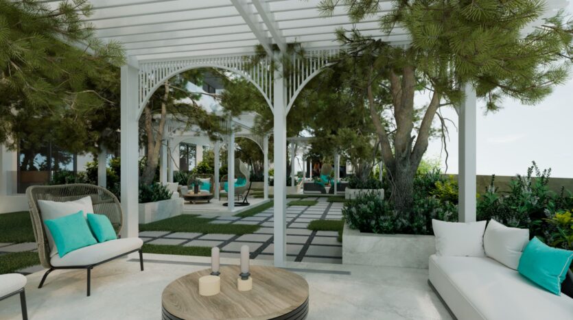 Un élégant salon extérieur avec des pergolas blanches, des sièges rembourrés et des accents sarcelle parmi la verdure luxuriante crée une atmosphère de jardin relaxante avec un décor moderne, parfait pour se détendre au Reef 996.
