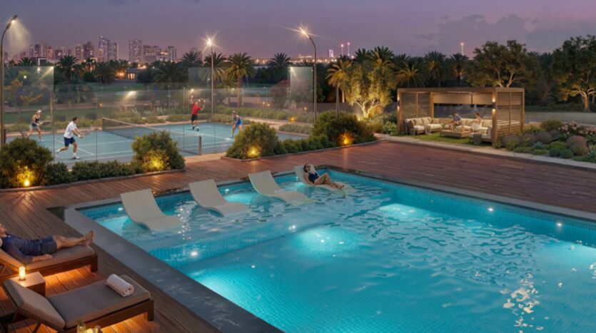 La piscine extérieure moderne de Rotana Residences est équipée de chaises longues, d'une personne se relaxant dans l'eau et d'un court de tennis éclairé avec des joueurs. La ligne d'horizon de la ville et les palmiers encadrent le ciel au crépuscule, avec un coin salon confortable à droite.
