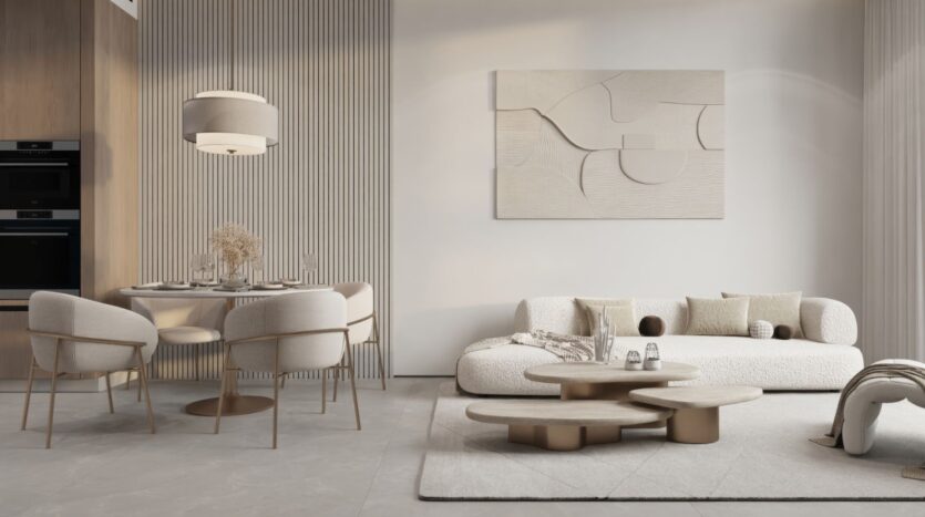 Salon et salle à manger modernes aux tons neutres à Sakura Gardens, avec une table ronde, quatre chaises rembourrées, un canapé en peluche, des œuvres d'art murales abstraites, des tables basses superposées et un décor minimaliste dans les tons beige et crème.