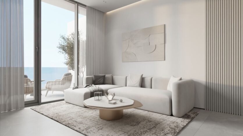 Le salon moderne aux tons neutres est composé d'un canapé sectionnel blanc, d'un tapis clair et d'œuvres d'art murales abstraites. Des fenêtres allant du sol au plafond révèlent un balcon avec des sièges extérieurs et une vue sur la mer, inspirée par la sérénité des jardins de Sakura.