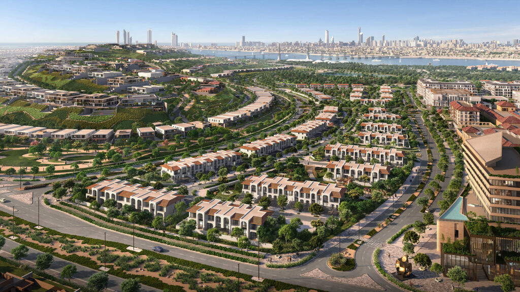 Vue aérienne d'un quartier résidentiel moderne et verdoyant au bord de l'eau, avec des rangées de villas, des parcs paysagers et des routes sinueuses menant à l'horizon d'une ville lointaine - tout savoir sur Modon Properties et ses développements innovants.