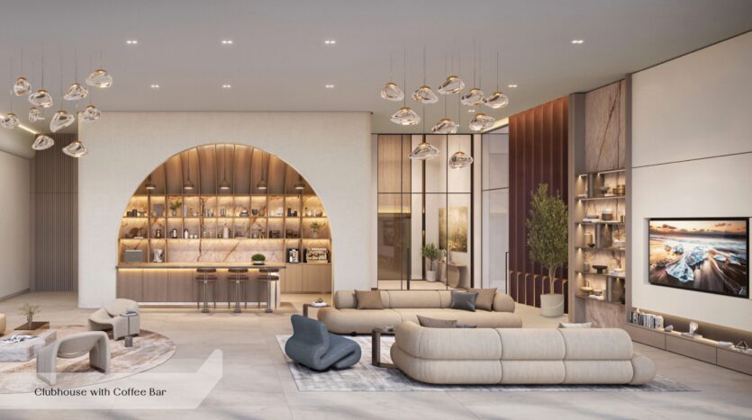 L'intérieur moderne du club-house d'Everly Place, conçu par Ellington, se caractérise par des canapés aux tons neutres, un comptoir de café incurvé agrémenté de suspensions, des étagères ouvertes, des touches de marbre, une télévision murale et un éclairage décoratif. L'espace est à la fois élégant et chaleureusement éclairé.
