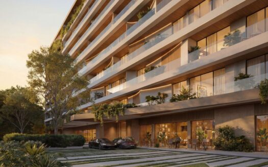Lunaya Terraces est un immeuble d'appartements moderne de plusieurs étages, doté de grands balcons, d'espaces verts abondants et de baies vitrées. Deux voitures de luxe sont garées devant, tandis que des coins salon en plein air et un aménagement paysager luxuriant entourent le site.