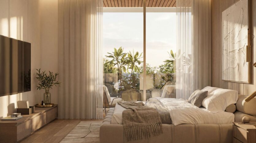 Cette chambre confortable et moderne du Lunaya Terraces est équipée d'un grand lit, d'une télévision, de meubles en bois et décorée dans des tons neutres. Des rideaux vaporeux habillent les portes vitrées donnant sur un balcon agrémenté de plantes, laissant entrer la lumière naturelle. Une couverture moelleuse est posée sur le lit.