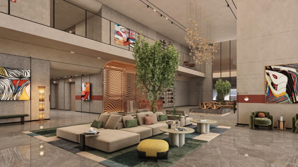 Le hall d'entrée moderne des Mövenpick Residences se distingue par ses sièges élégants, ses plantes vertes, ses œuvres d'art abstrait contemporain accrochées aux murs, ses grandes baies vitrées et son sol en marbre brillant. Une cloison en bois et un lustre ajoutent une touche d'élégance à cet espace ouvert et spacieux.