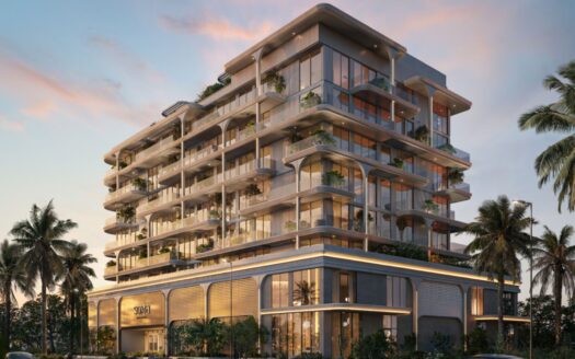 Les résidences Soma, des immeubles modernes à plusieurs étages dotés de grandes baies vitrées, de balcons spacieux agrémentés de plantes et entourés de palmiers, le tout sur fond d'un ciel coloré au coucher du soleil.
