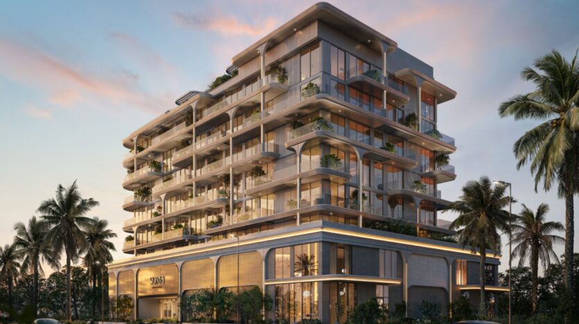 Les résidences Soma, des immeubles modernes à plusieurs étages dotés de grandes baies vitrées, de balcons spacieux agrémentés de plantes et entourés de palmiers, le tout sur fond d'un ciel coloré au coucher du soleil.