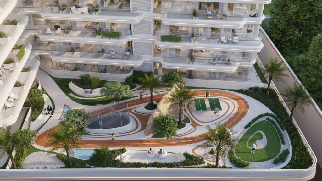 Vue aérienne de la cour du complexe d'appartements Weston by Wadan, avec une piste de course, un aménagement paysager, des bancs, une aire de jeux, un terrain de basket-ball et des personnes profitant des aménagements extérieurs.