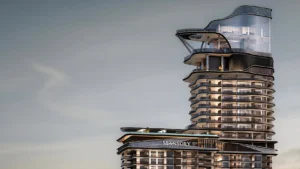 Un gratte-ciel moderne à l'architecture courbée et futuriste, doté de grandes baies vitrées, de balcons et de terrasses. Une enseigne indiquant « Mansory Residences » est visible à un certain étage — l'endroit idéal pour les investisseurs en quête de luxe sous le ciel dégagé de la ville.